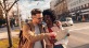 a man and woman looking at a map in the city