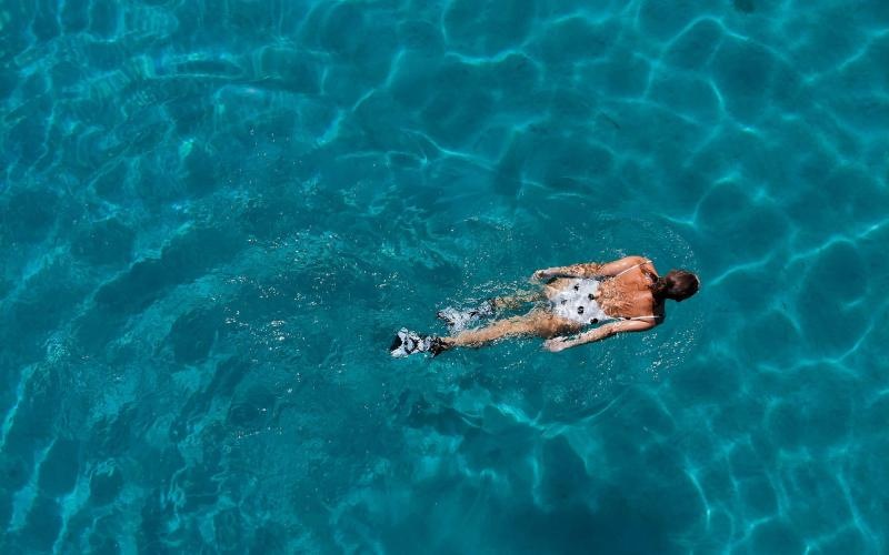 overhead shot of a woman swimming in a pool