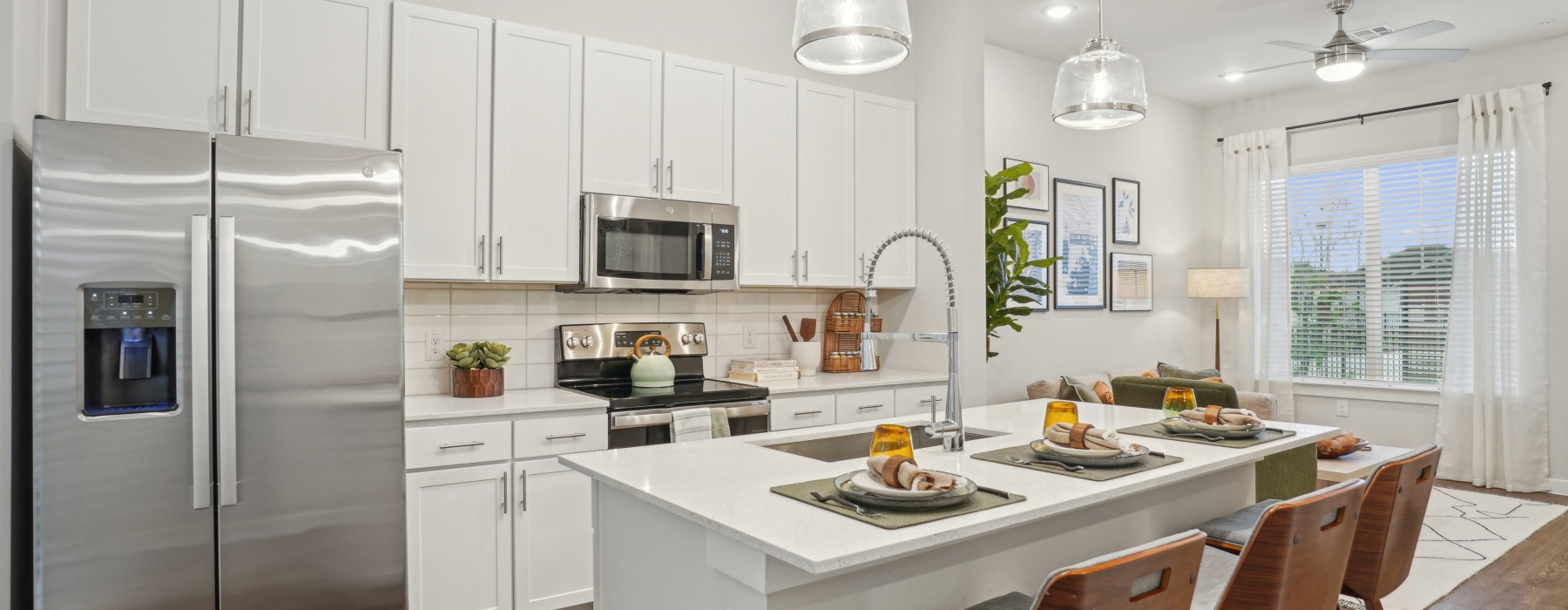 kitchen with stainless steel appliances and white cupboards